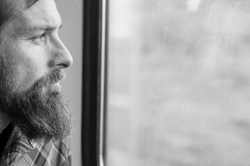 handsome man traveling on a train with headphones