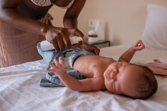 Mom disinfecting newborn umbilical cord