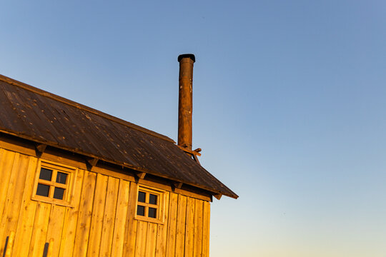 Wooden Building With A Heating Stove Pipe