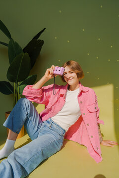 Woman photographing with single use film camera 