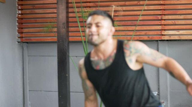 Athletic man performing landmine exercises with barbell, showcasing strength and fitness