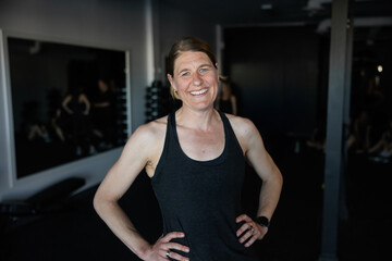 Smiling Woman Embracing Fitness Joy in Community Gym