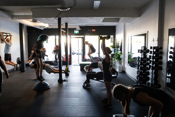 Community Fitness Members Exercising Together in a Gym Setting