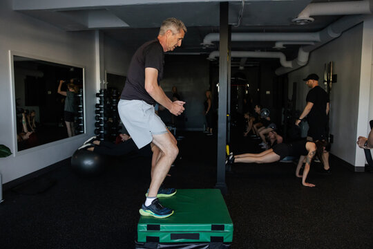 Group Fitness Session With Diverse Participants Exercising Together