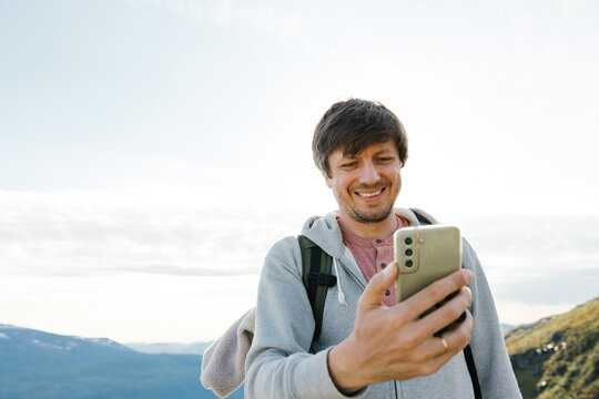 Man with a mobile phone in the mountains