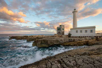 Sunset at lighthouse of saint cross (faro di santa croce) Augusta Sicily, Italy. The most beautiful lighthouse on the island. Province of Syracuse