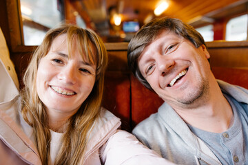 A couple took a selfie photo in a train