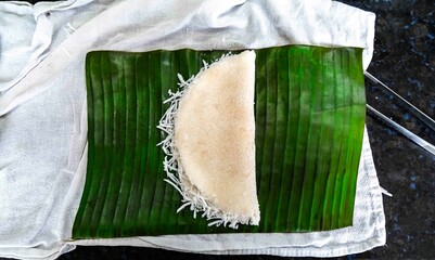 Traditional Brazilian tapioca with coconut served on a banana leaf. Amazonian tapioca
