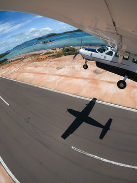Wing mounted view of single engine aircraft taking off.