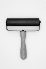 Brayer or rubber pressure roller. Hand roller tool. Black and white.