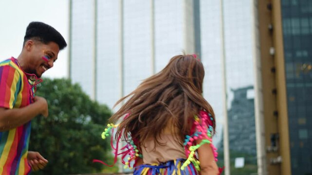 Friends Following a Brazilian Carnival Block Party in Festive Costumes. Joyful Group Walking and Dancing Outdoors at a Vibrant Carnaval Street Parade in the City