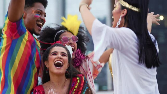Laughing Friends Dancing at Brazilian Carnival Street Party in Colorful Costumes. Group of Joyful People Celebrating Vibrant Carnaval Festivities Outdoors in the City