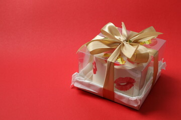 Colorful bento cake packed in a box with a bow on color background