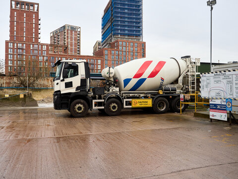 Cemex Salford, cement mixer truck parked at an urban construction site on a cloudy day.