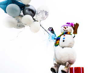 New year greeting card with snowman. Smiling snowman with helium balloons and gift. Cute snowman in...