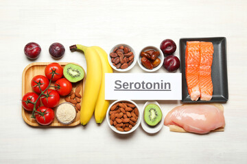 Word Serotonin and products on white wooden table, flat lay