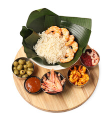 Cut banana leaves with different food and sauce isolated on white, above view