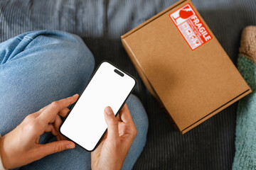 A woman uses a mobile phone with white screen
