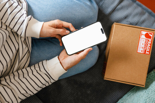 A woman uses a mobile phone with white screen