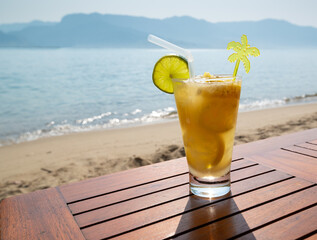 Brazilian lemon caipirinha in a glass over wooden table in a beach on a sunny day