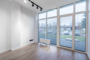 Modern Empty Room with Large Windows and Wooden Flooring. Home Interior