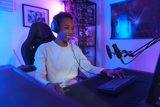 Young Man Streaming at Computer Desk with Headset