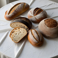 Variety of artisan bread types, including ciabatta, rye, and multigrain, placed on a white tablecloth, minimalistic composition, focus on texture and detail