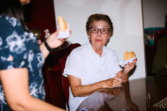 Senior Woman Enjoying Dessert at Party
