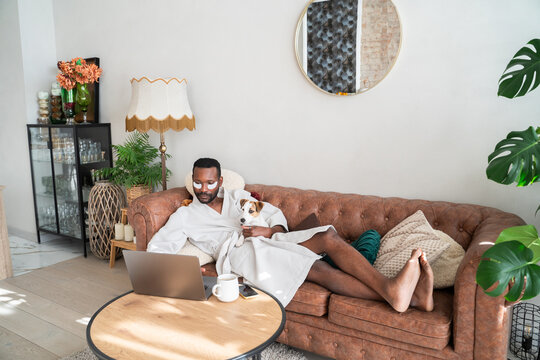 Man With Eye Patches Using Computer At Home