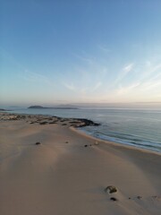 Aerial view of golden sand beach with waves crashing. Taken in Fuerteventura. 