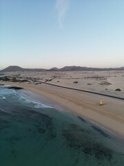 Aerial view of golden sand beach with waves crashing. Taken in Fuerteventura. 
