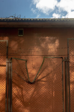 Damaged Fence with Barbed Wire