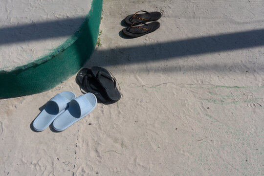 Sandals and Flip-Flops on Sand

