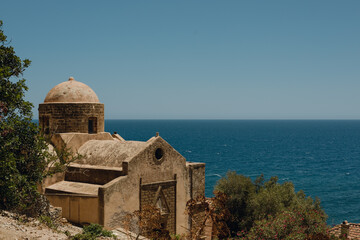 Historic coastal building overlooking the serene blue sea 