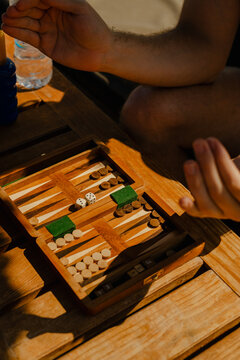 Playing backgammon with friends outdoors on a sunny day at the beach