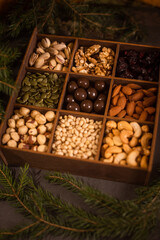 many nuts in wooden gift box for christmas as christmas background