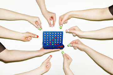 People playing Connect Four game. Cooperation, teamwork and strategy