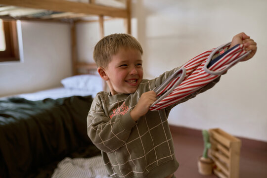 A boy pretending to shoot with a toy gun