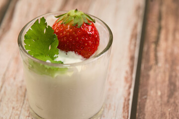 Yogurt with Strawberry and Cilantro on Wooden Surface
