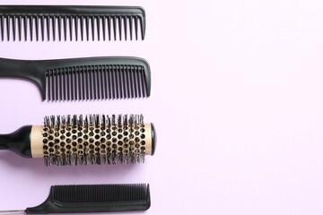 Professional combs and hairdresser tools on color background, top view