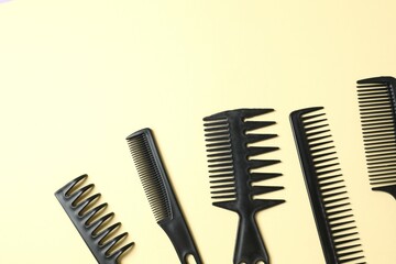 Professional combs and hairdresser tools on color background, top view