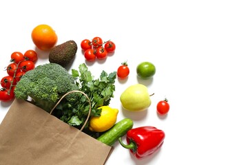 Paper bag, vegetables and fruits on white background, space for text