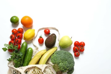 String bag with vegetables and fruits on white background
