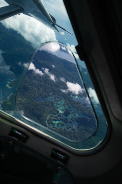 Aerial photo over Raja Ampat in Indonesia through cockpit window.