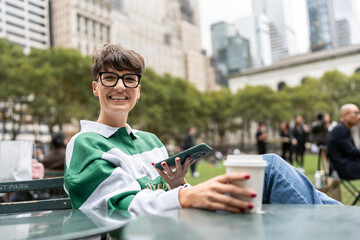 Smiling freelancer working remotely in bryant park, manhattan