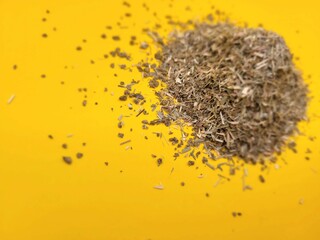 Dried pieces of aromatic lemon grass on a yellow background.
