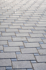 A closeup view of a brick pavement with a diagonal pattern