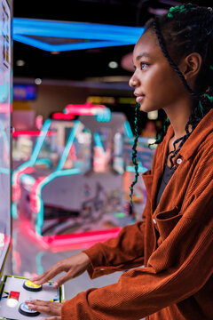 Hipster young woman having fun at gaming zone