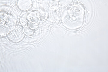 Rippled surface of clear water on white background, top view