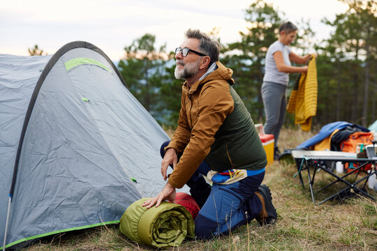 Man and woman are setting up camp